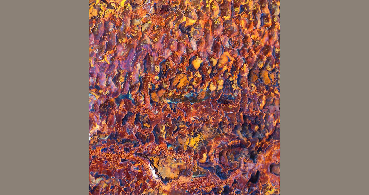 Red orange and blue patterns on a cave wall