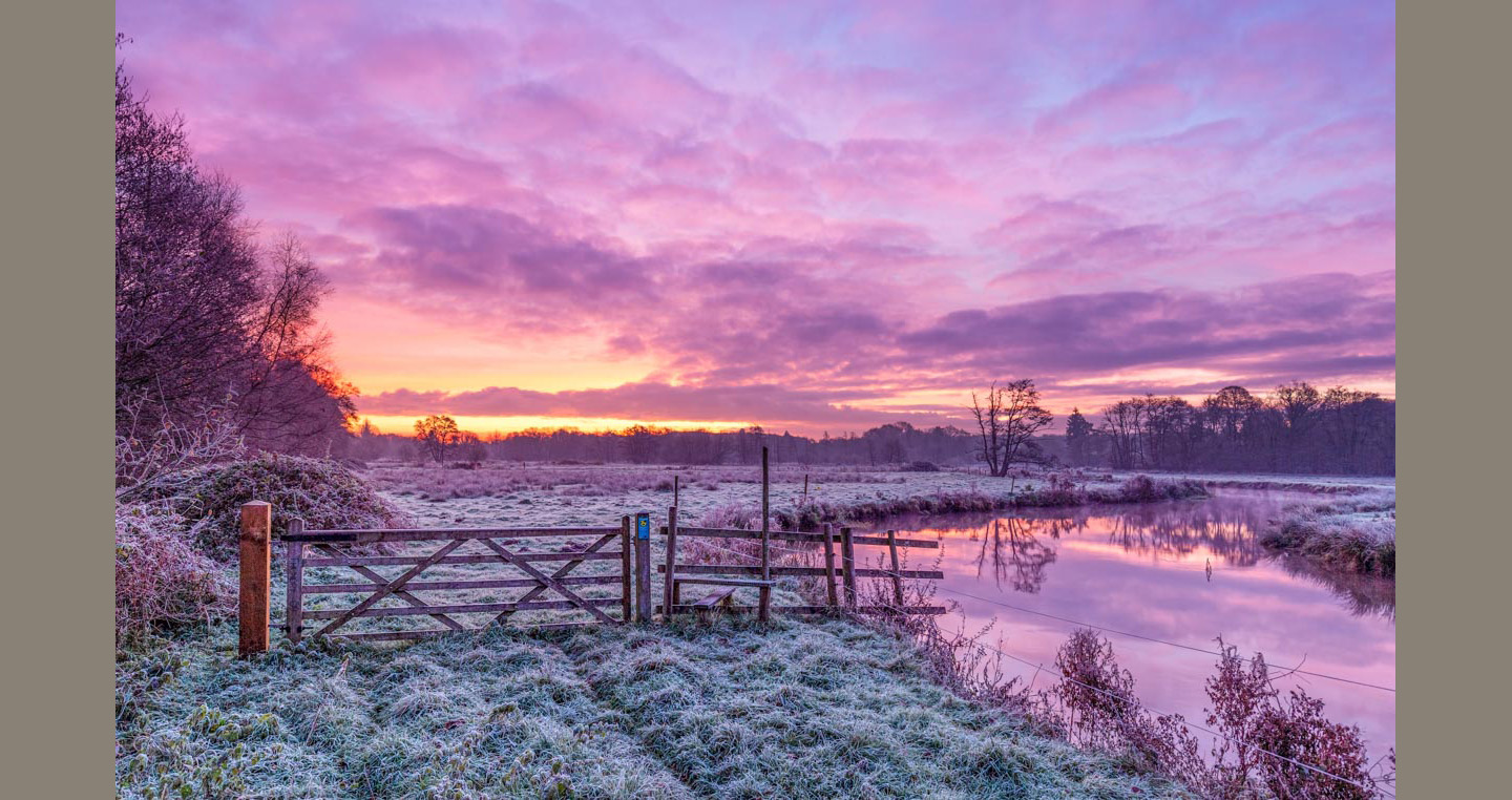Landscape photograph - sunrises over frosty meadows and a calm river